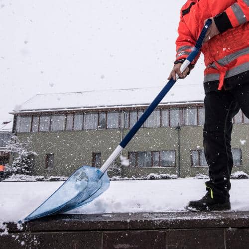 Notfallservice Leistung im Winterdienst: Abbildung Mann mit Schneeschippe